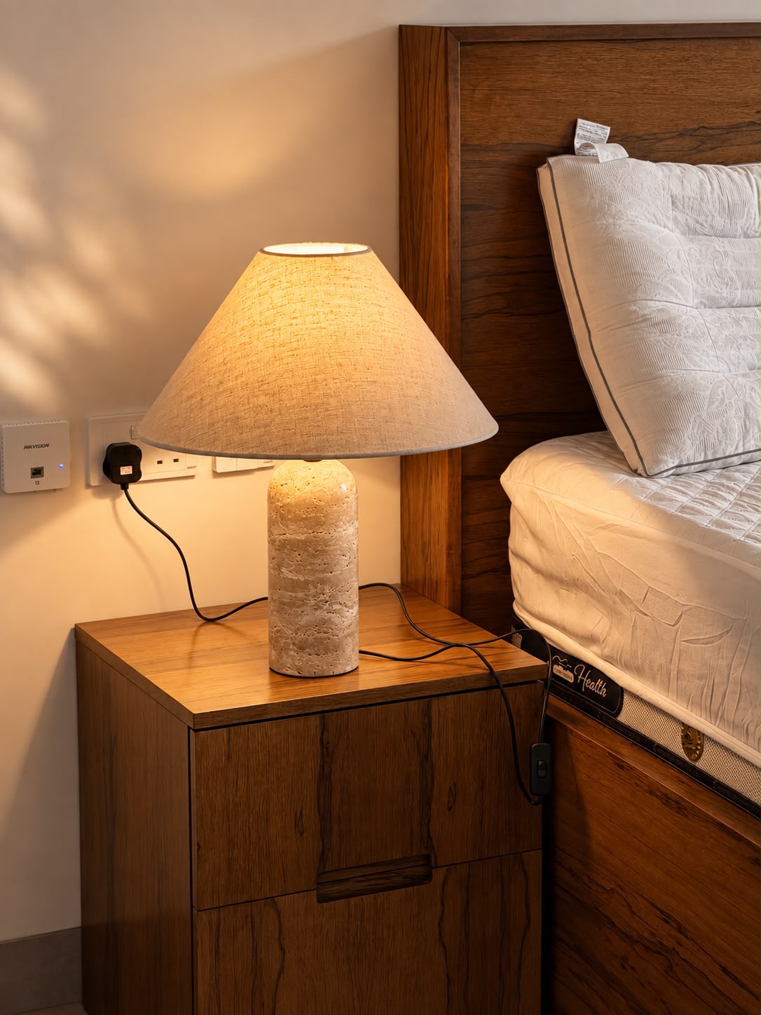 Close view of the bedside lamp's textured base and illuminated shade